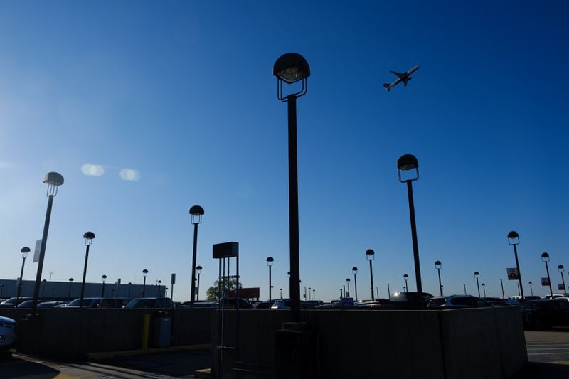 An airplane is seen from the domestic south terminal parking lot at Hartsfield-Jackson airport in Atlanta on Friday, April 8, 2022.   (Arvin Temkar / arvin.temkar@ajc.com)