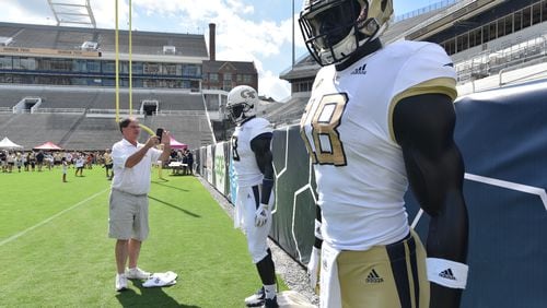 August 11, 2018 Atlanta - John Southard, son of Yellow Jackets legend Jimmy Southard (a three-year starter quarterback for coach Bobby Dodd in the late 40s), takes a picture of new Georgia Tech football uniforms during an annual Georgia Tech Football Fan Day at Bobby Dodd Stadium on Saturday, August 11, 2018. HYOSUB SHIN / HSHIN@AJC.COM