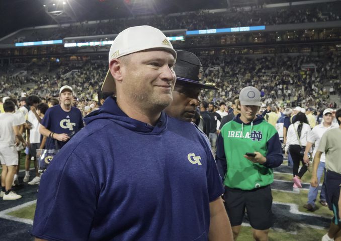 Georgia Tech Yellow Jackets head coach Brent Key smiles as he leaves the field victorious after the win.  (Bob Andres for the Atlanta Journal Constitution)