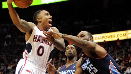 Atlanta Hawks guard Jeff Teague (0) is fouled by Charlotte Bobcats' Al Jefferson (25) in the first half of their NBA basketball game on Saturday, Dec. 28, 2013, in Atlanta. (AP Photo/David Tulis)