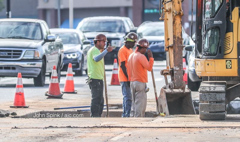Two lanes of Holcomb Bridge Road are knocked out at Alpharetta Highway with road repairs after a water main break Tuesday afternoon. JOHN SPINK / JSPINK@AJC.COM