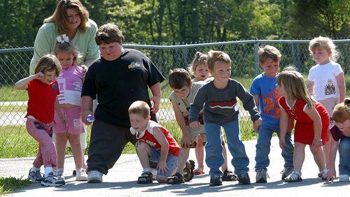 Doctors are diagnosing children in growing numbers with ailments usually seen in adults, such as hypertension, high cholesterol, Type 2 diabetes and joint problems, and they say childhood obesity is behind the trend. Here, Andy Hamblin, in black, prepares to race with his preschool classmates at Poplar Creek Elementary School in Siler, Ky., on May 6, 2004. Andy is five years old and weighs close to 188 pounds. (Charles Bertram/The Lexington Herald-Leader/MCT)