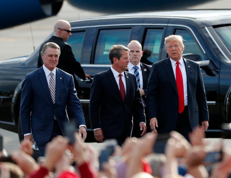 Brian Kemp, center, walks with President Donald Trump, right, and U.S. Sen. David Perdue during a 2018 campaign event when Kemp was running for governor. Now, Perdue is said to be considering a run against Kemp with Trump's support. (AP Photo/John Bazemore)