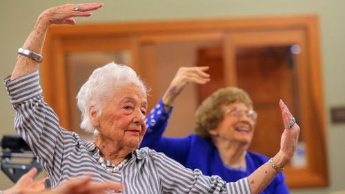 Dolores Combs, 91, follows along with ballet instructor Vanessa Woods, of Vitality Ballet, during class at The Willows at Brooking Park in Chesterfield on Wednesday, Aug. 2, 2017. Vitality Ballet brings dance to older adults using modified ballet steps that can be done entirely from a seated position. (Cristina M. Fletes/St. Louis Post-Dispatch/TNS)