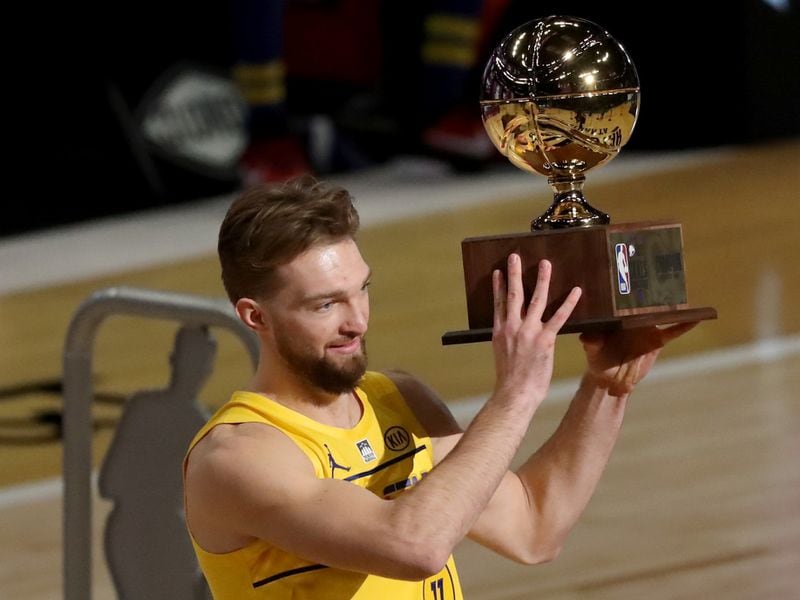 Indiana Pacers forward Domantas Sabonis hoists the trophy after winning the skills competition during NBA All-Star night Sunday, March 7, 2021, at State Farm Arena in Atlanta. (Curtis Compton/ccompton@ajc.com)