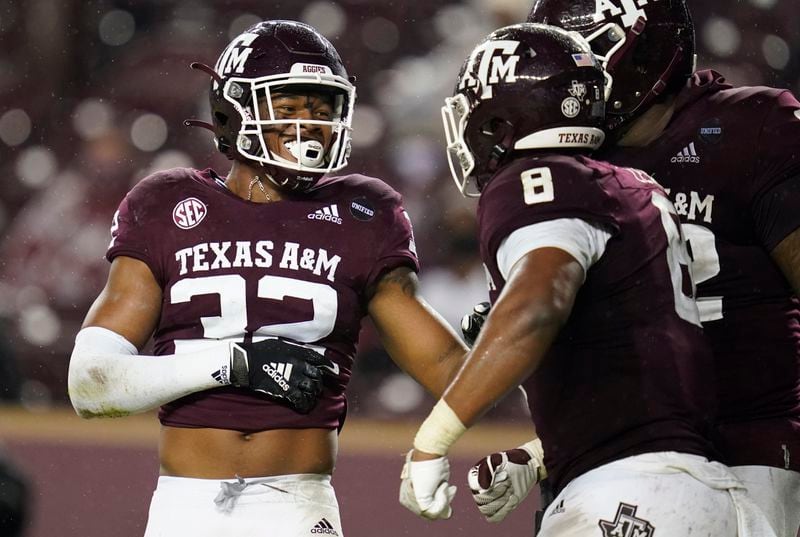 Texas A&M linebacker Andre White Jr. (32) smiles to teammates after sacking LSU quarterback Max Johnson during the third quarter of an NCAA college football game Saturday, Nov. 28, 2020, in College Station, Texas. (AP Photo/Sam Craft)