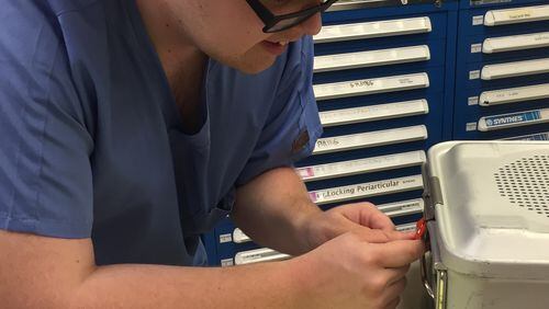 Bartow County student Mark Cole works at Cartersville Medical Center to label surgical instrument containers ready for sterilization. Cole is part of the school district’s Project Search program that provides internships and workplace preparedness experiences for special need students.