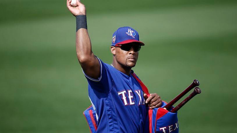 Texas Rangers third baseman Adrian Beltre tosses a baseball to a fan during the fifth inning of the team's spring training baseball game against the Chicago White Sox on Thursday, March 8, 2018, in Surprise, Ariz. Going into his 21st big-league season, Beltre is one of only two current players who have played at least 20 MLB seasons.(AP Photo/Ross D. Franklin)