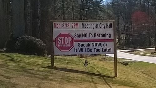 Several yard signs line a portion of New Macland Road north of Macedonia Road that express opposition to a proposed townhouse community in Powder Springs. The City Council is expected to vote on the matter on March 18. Contributed