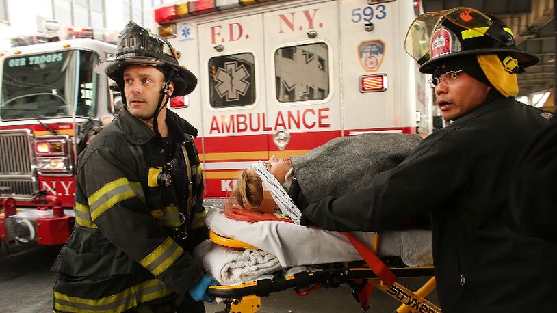 An injured person is carried to a waiting ambulance following an early morning ferry accident during rush hour in Lower Manhattan on January 9, 2013 in New York City.