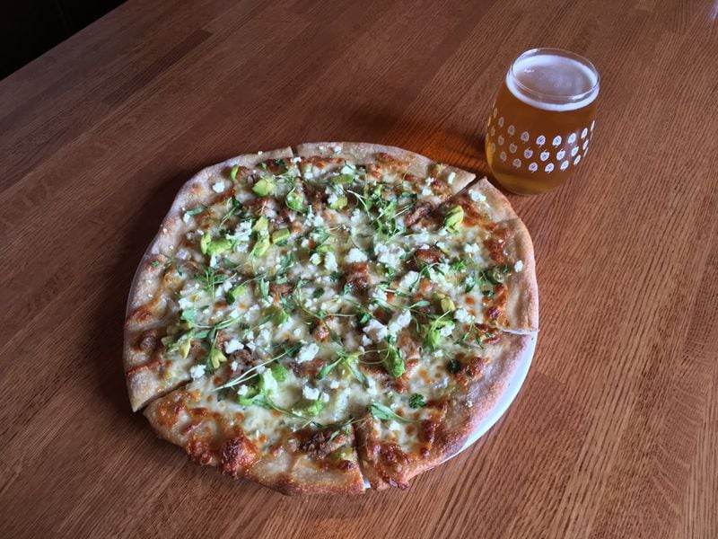 At Torched Hop Brewing Co. in Midtown, the Carnitas pizza holds adobo roasted pork, avocado, salsa verde, sweet onion and feta along with a heavy dash of Mexican spices. CONTRIBUTED BY TORCHED HOP BREWING CO.