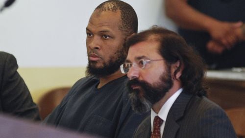 Siraj Ibn Wahhaj, left, sits next to public defense attorney Aleks Kostich at a first appearance in New Mexico state district court in Taos, N.M., Wednesday, Aug. 8, 2018, on accusations of child abuse and abducting his son from the boy’s mother. Authorities were waiting to learn if human remains found at a disheveled living compound were those of Wahhaj’s missing son. Authorities also allege Wahhaj was conducting weapons training with assault rifles at the compound near the Colorado border where they say they found 11 hungry children living in filthy conditions in a raid Friday. (AP Photo/Morgan Lee)