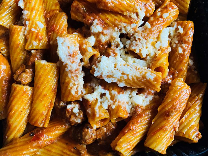 This takeout order includes rigatoni with house-made mild fennel sausage, Calabrese chiles, shallots, Marsala, pomodoro and pecorino cheese. Bob Townsend for The Atlanta Journal-Constitution