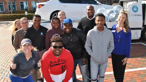 Delta Community Credit Union gave a Smyrna man a free car. The man, Brian Roberts (blue hat), posed with his sons and Delta Community staff when they picked up the car at the Vinings location of the credit union Tuesday, Jan. 11, 2016.