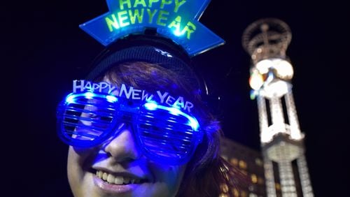 Daesum Butler, of Whitesburg, wears her New Year’s Eve glasses at Underground Atlanta during the 2015 New Year’s Eve Peach Drop. The music, fireworks and the descent of the 800-pound Peach that are traditionally part of the New Year’s Eve celebration at Underground may take place at Woodruff Park this year. HYOSUB SHIN / HSHIN@AJC.COM