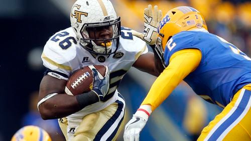 PITTSBURGH, PA - OCTOBER 08: Dedrick Mills #26 of the Georgia Tech Yellow Jackets rushes in the first half during the game against Terrish Webb #2 of the Pittsburgh Panthers on October 8, 2016 at Heinz Field in Pittsburgh, Pennsylvania. (Photo by Justin K. Aller/Getty Images)