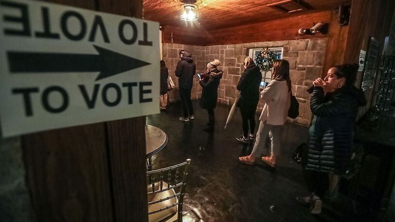 Voters lined up to cast their ballots at Park Tavern in Atlanta on Tuesday, Dec. 6, 2022.