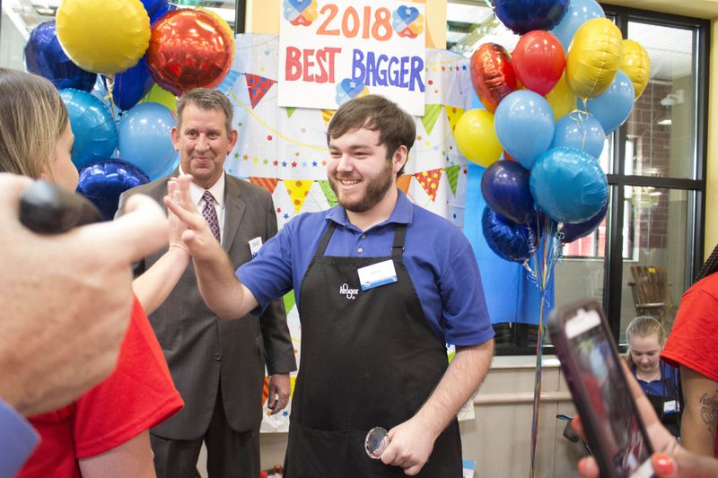 Devin Ferrell, from McDonough, Georgia, celebrates after being named the 2018 Best Bagger for the 22nd annual Kroger Georgia Bag-Off on Wednesday at the Kroger on Glenwood Avenue. Ferrell won $750 in college scholarships and will represent Kroger at the Georgia Food Industry Association's 'Bag Off' in July. (Jenna Eason / Jenna.Eason@coxinc.com)