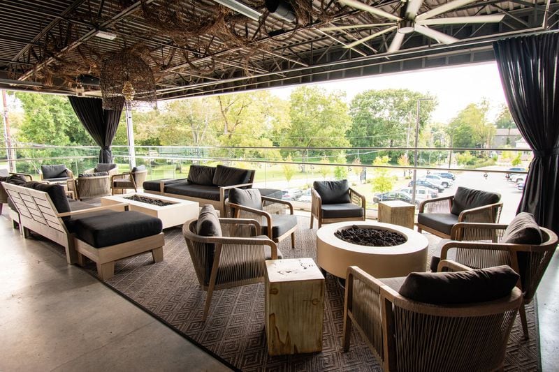 The second-floor patio at Arnette’s Chop Shop in Brookhaven boasts lounge seating around fire pits. CONTRIBUTED BY HENRI HOLLIS