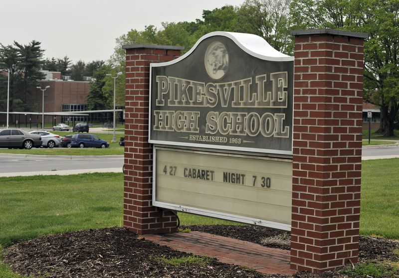This undated photo shows the The Pikesville High School sign on the school property. Baltimore County Police Chief Robert McCullough and other local officials speak at a news conference in Towson, Maryland, on Thursday, April 25, 2024. The officials discussed the arrest of a high school athletic director on charges that he used artificial intelligence to impersonate a principal on an audio recording that included racist and antisemitic comments. (Lloyd Fox/The Baltimore Sun via AP)
