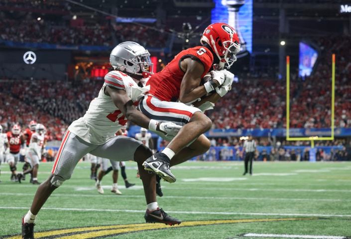 Georgia Bulldogs wide receiver Adonai Mitchell (5) makes a touchdown catch to take the lead after the PAT kick during the fourth quarter of the College Football Playoff Semifinal between the Georgia Bulldogs and the Ohio State Buckeyes at the Chick-fil-A Peach Bowl In Atlanta on Saturday, Dec. 31, 2022.  Georgia won, 42-41. (Jason Getz / Jason.Getz@ajc.com)