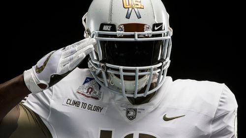 Army will be all in white this weekend, as modeled here by Nike. (Nike/Dustin Satloff via AP)