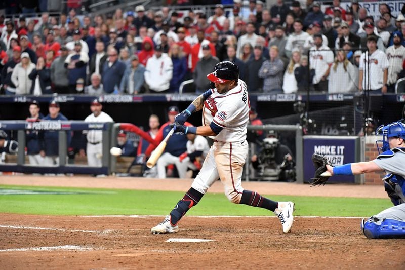 Braves leftfielder Eddie Rosario hits the walk-off single that scored shortstop Dansby Swanson in the ninth inning against the Los Angeles Dodgers in Game 2 of the NLCS Sunday, Oct. 17, 2021, at Truist Park in Atlanta. The Braves won 5-4 to take a 2-0 series lead. (Hyosub Shin / Hyosub.Shin@ajc.com)