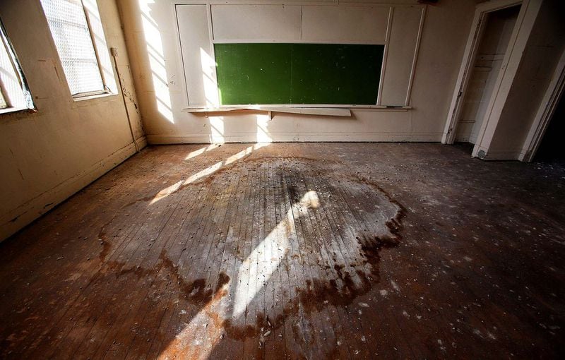 The floor of a second story classroom shows water damage from a leaky roof. (Lannis Waters/The Palm Beach Post)
