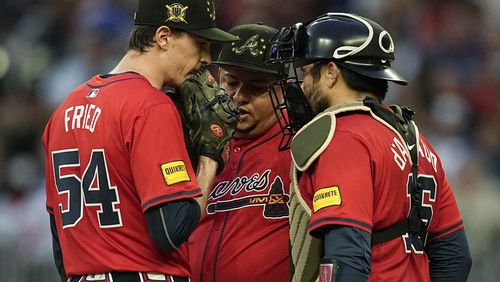 Atlanta Braves' Max Fried (54) speaks with bullpen coach Erick Abreu, center, and catcher Travis d'Arnaud (16) on the mound in the third inning of a baseball game against the San Diego Padres, Friday, May 17, 2024, in Atlanta. (AP Photo/Mike Stewart)