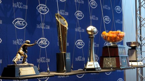 The Heisman Trophy and College Football Playoff trophy are displayed alongside the ACC Football and Orange Bowl trophies during the 2017 ACC Football Kickoff media event in Charlotte, N.C., Thursday, July 13, 2017. (Photo by Sara D. Davis, the ACC.com)