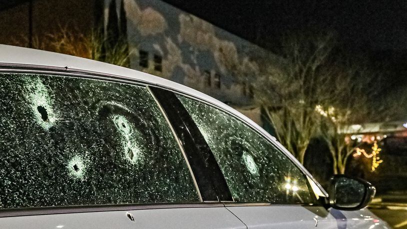 Multiple vehicles were damaged by bullets Sunday night when gunfire rang out in the parking lot of Loca Luna on Amsterdam Avenue. (John Spink / John.Spink@ajc.com)
