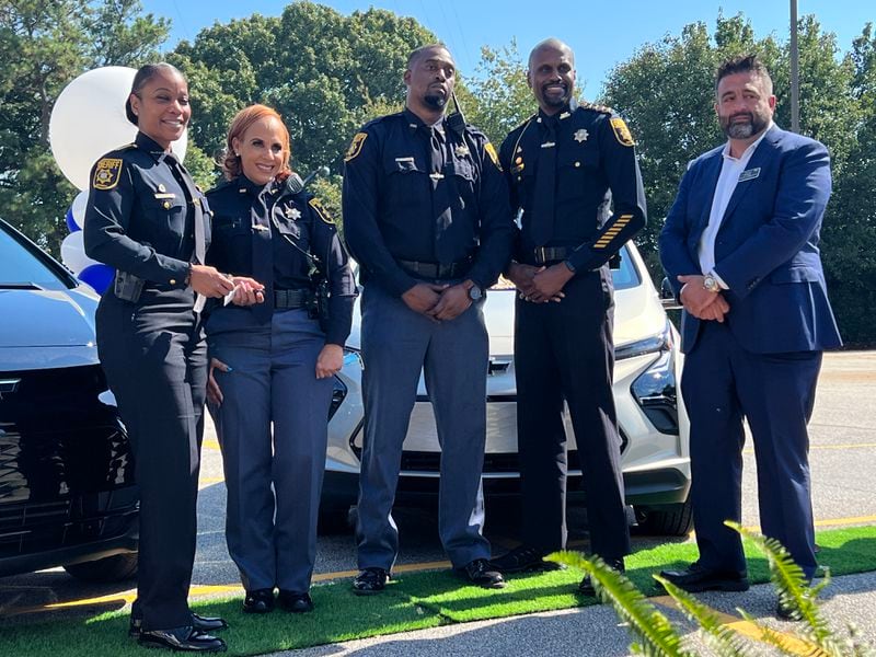 From left, DeKalb County Sheriff Melody Maddox, detention officer Brenda Coley, detention officer Patrick Alexander, Chief Deputy Randy Akies and Ralph Sorrentino of Jim Ellis Automotive Group pose for photos during a Thursday morning event announcing a take-home vehicle program for jailers.