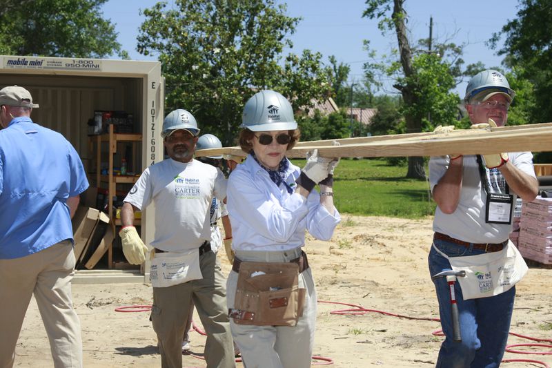For more than three decades, Jimmy and Rosalynn Carter led annual week-long Carter Work Projects for Habitat for Humanity, a nonprofit organization that helps to build and renovate homes for those in need. Rosalynn Carter is pictured here carrying a truss in Pascagoula, Miss., in 2008. (Gregg Pachkowski / Habitat for Humanity)