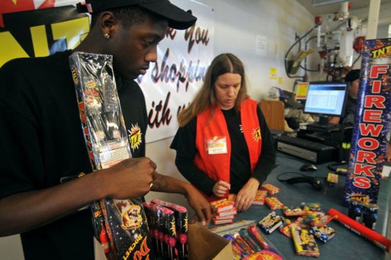 Cashiers Brandon Mann of Trotwood and Beth Landis of Brookeville ring up purchases at TNT Fireworks.