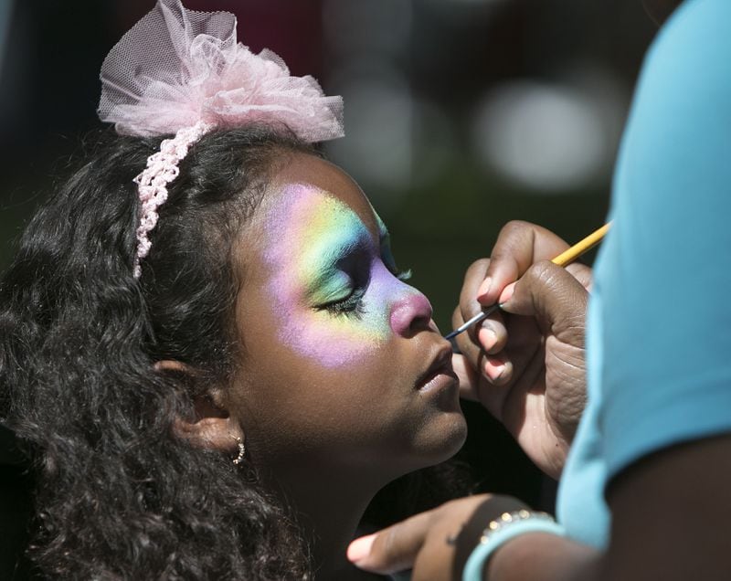 Five-year-old Maya Monroy gets her face painted by Janelle Perrilliat (both cq) during the Roswell Lavender Festival on the grounds of historic Barrington Hall in Roswell on Saturday June 13th, 2015. Visitors enjoyed demonstrations, children's activities, yoga in the Zen Zone, live music, arts, crafts at "all things Lavender." (Photo by Phil Skinner)