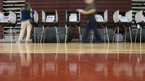Woodstock residents will have to visit two polling places Nov. 6 to vote in both the statewide general election, and the municipal special election to roll back to 11 a.m. the Sunday serving hour for alcohol, the city advises. AJC FILE