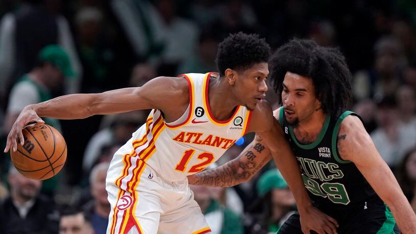 De'Andre Hunter drives against the defense of Celtics forward Justin Champagnie (99) during Sunday's game.