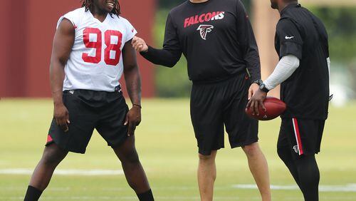 Falcons rookie defensive end Takkarist McKinley talks with team staffers during rookie minicamp on Friday. Curtis Compton/ccompton@ajc.com