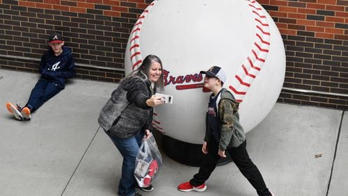 Baseball fans take a selfie during 2023 Braves Fan Fest at  the Truist Park, Saturday, Jan. 21, 2023, in Atlanta. After not holding the event for several years due to the pandemic, the team will bring back the fan event Saturday. Fan Fest will be held at Truist Park and The Battery from 10 a.m. to 4 p.m. The free event will feature player autographs and photos, Q&A sessions, clinics, games, on-field activities, live entertainment and panel discussions with players and coaches. (Hyosub Shin / Hyosub.Shin@ajc.com)