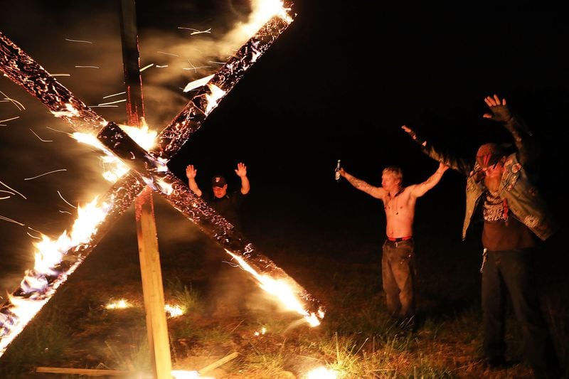 Members of the National Socialist Movement, a neo-Nazi group, hold a swastika-burning in Draketown, Ga., on April 21, 2018, following their rally that day in Newnan, Ga. (Photo by Spencer Platt/Getty Images) 