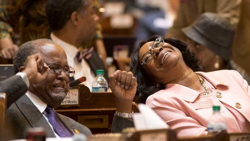 02/28/2018 -- Atlanta, GA -  House Minority Whip Rep. Carolyn Hugley, D - Columbus, left, laughs while speaking with Rep. Al Williams, D - Midway, at the House Chambers during Crossover day at the Georgia State Capitol in Atlanta, Wednesday, February 28, 2018. ALYSSA POINTER/ALYSSA.POINTER@AJC.COM