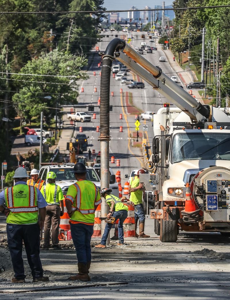 Crews with the Georgia Department of Transportation worked to repair and repave a portion of Buford Highway in Brookhaven after the road surface collapsed Wednesday. 