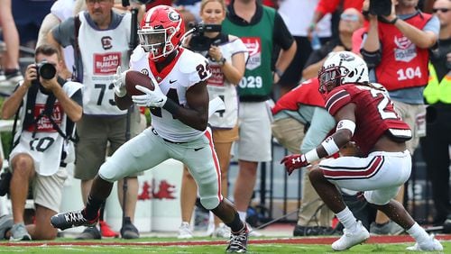 Georgia defensive back Malaki Starks intercepts a Spencer Rattler pass intended for South Carolina running back Juju McDowell and makes a long return setting up a Georgia scoring drive Saturday, Sept. 17, 2022, in Columbia.   “Curtis Compton / AJC file"