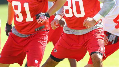 Falcons tight ends Jacob Pedersen (left) and Levine Toilolo (right) run drills during team practice on Tuesday, June 10, 2014, in Flowery Branch. (By Curtis Compton/CCompton@ajc.com)