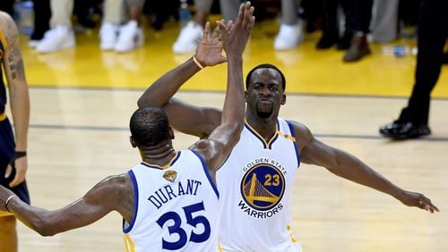 Draymond Green #23 and Kevin Durant #35 of the Golden State Warriors react after a play against the Cleveland Cavaliers in Game 1 of the 2017 NBA Finals at ORACLE Arena on June 1, 2017 in Oakland, California.