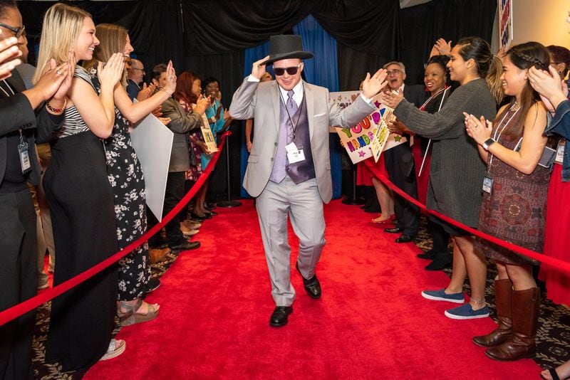 Dale Potter of Dunwoody tips his top hat as he strolls the red carpet at the “Night to Shine” prom hosted by First Baptist Church Atlanta. The effort involves churches in all 50 states and 16 countries, with help from the Tim Tebow Foundation. CONTRIBUTED BY FIRST BAPTIST CHURCH ATLANTA