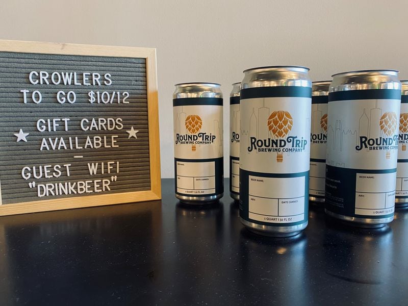 Crowlers and canned beer are available to go at Round Trip Brewing’s taproom on Seaboard Industrial Boulevard NW in Atlanta. (Bob Townsend for The Atlanta Journal-Constitution)