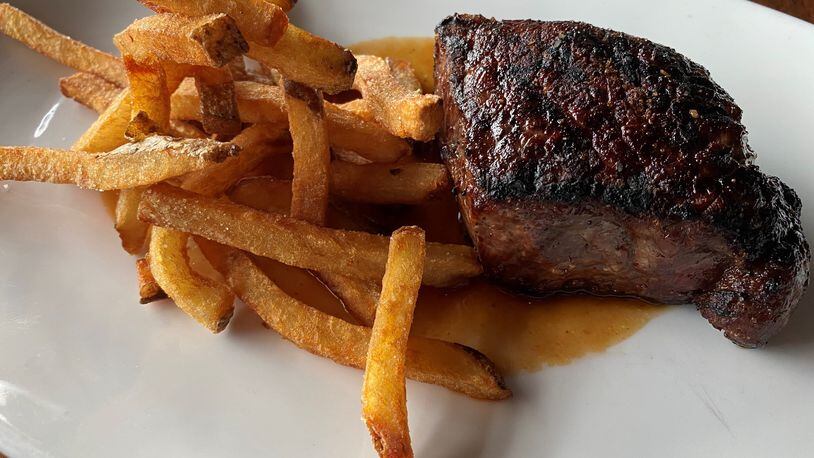 Kaiser’s Chophouse in Sandy Springs offers an 8-ounce prime New York strip steak with hand-cut fries and garlic-pepper dust. Bob Townsend for The AJC