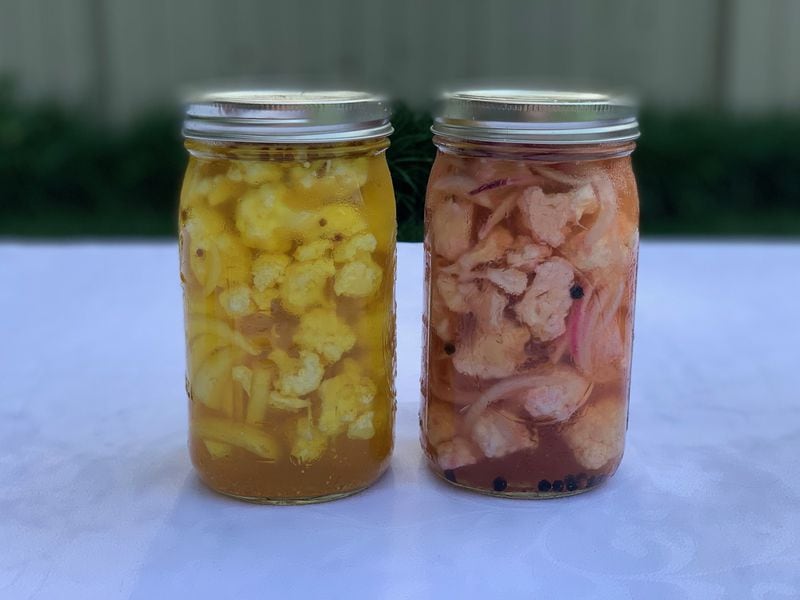 Cauliflower pickles two ways: with saffron and coriander seeds (left) and red onion and black peppercorns (right). CONTRIBUTED BY KELLIE HYNES