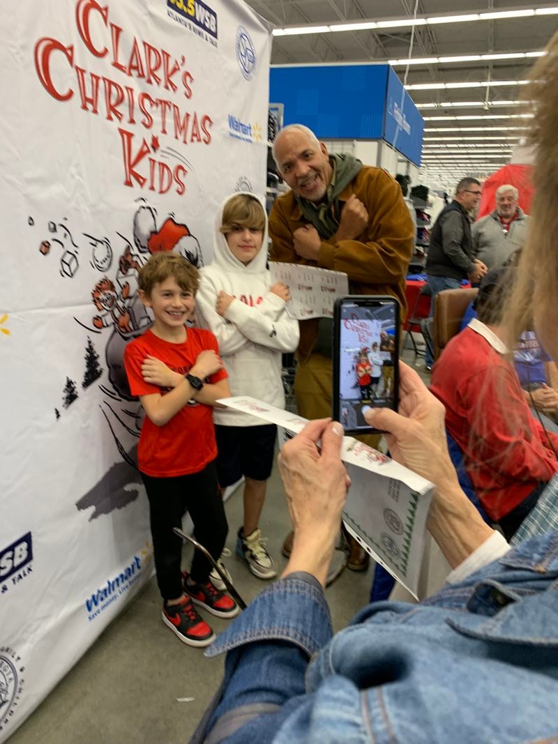 WSB evening host Shelley Wynter joins Asher Eisner, 10, and his brother Arthur, 7, at Clark's Christmas Kids at the Roswell Walmart December 2, 2022. RODNEY HO/rho@ajc.com
